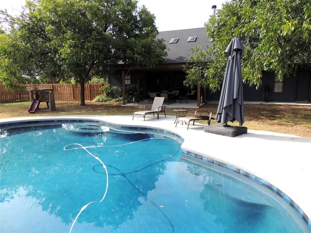 rear view of house with a yard and a patio