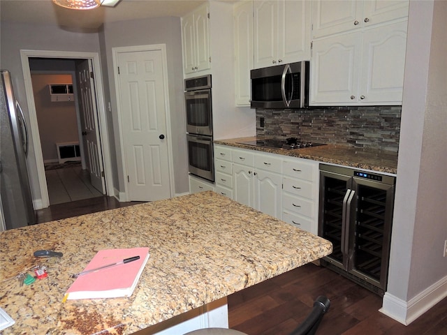 kitchen with tasteful backsplash, stainless steel appliances, white cabinets, and beverage cooler