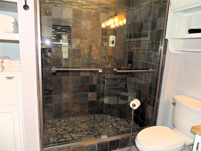 bathroom with walk in shower, vanity, and toilet