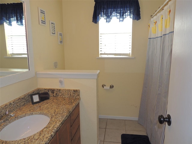 bathroom with tile patterned flooring, vanity, and a wealth of natural light