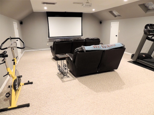 home theater room featuring carpet and vaulted ceiling