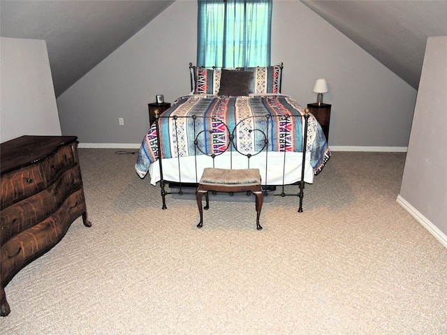 carpeted bedroom with vaulted ceiling