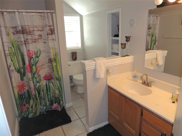 bathroom featuring tile patterned floors, a textured ceiling, vanity, vaulted ceiling, and toilet