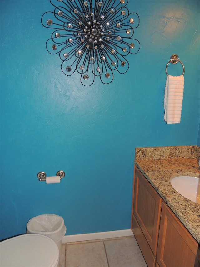 bathroom featuring tile patterned flooring, vanity, and toilet