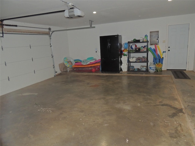 garage featuring electric panel and a garage door opener