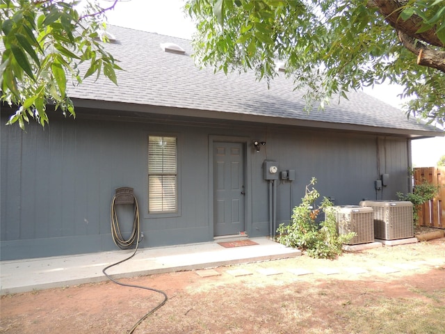 rear view of property featuring central air condition unit