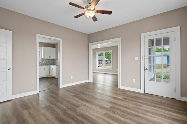 interior space with ceiling fan and hardwood / wood-style floors