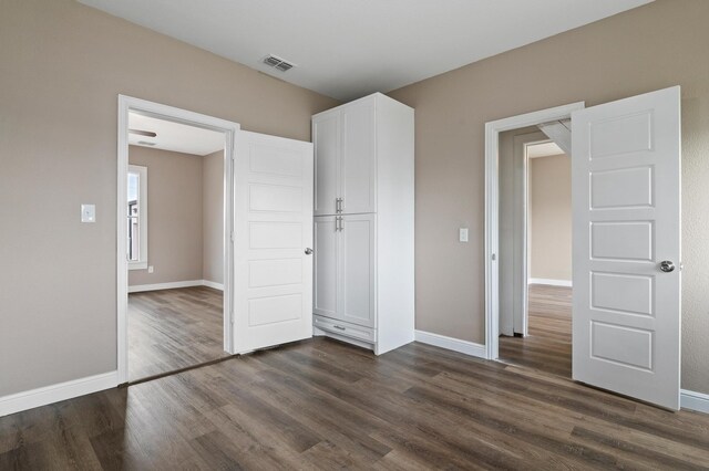 unfurnished bedroom with a closet and hardwood / wood-style floors