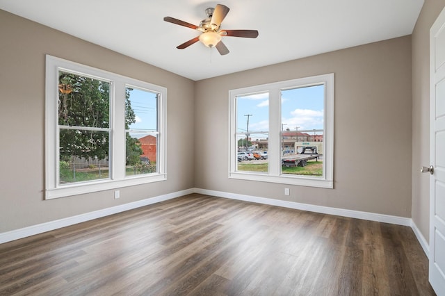 unfurnished room featuring dark wood-type flooring and ceiling fan