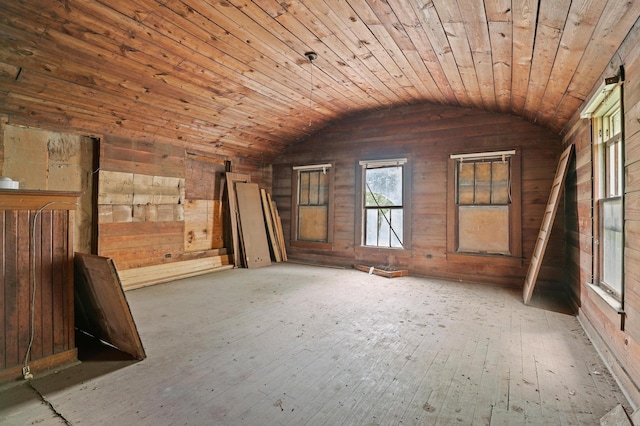 interior space with wooden ceiling, wooden walls, lofted ceiling, and light hardwood / wood-style floors