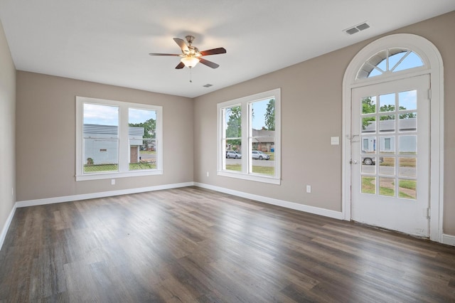 unfurnished room with dark hardwood / wood-style flooring and ceiling fan