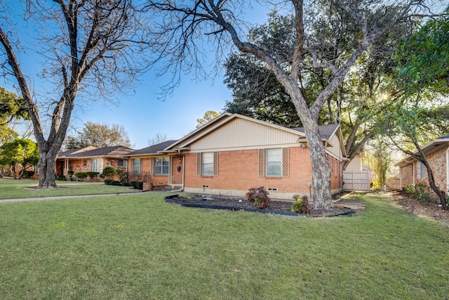 ranch-style home featuring a front yard