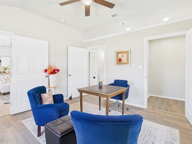 office with visible vents, baseboards, lofted ceiling, and light wood-style flooring