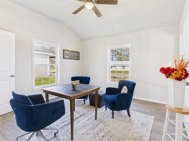 office area featuring vaulted ceiling, wood finished floors, a healthy amount of sunlight, and baseboards