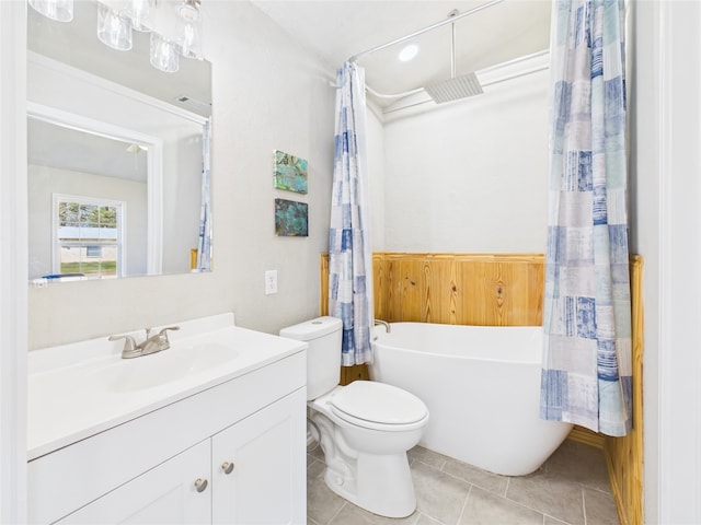 full bathroom featuring a freestanding tub, visible vents, toilet, tile patterned flooring, and vanity