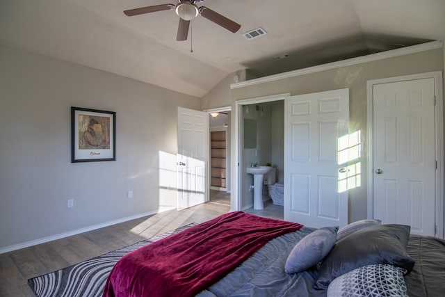 bedroom featuring light hardwood / wood-style flooring, ensuite bath, ceiling fan, and lofted ceiling