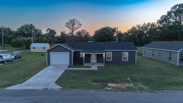 ranch-style home with a lawn, an attached garage, and concrete driveway