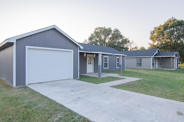 single story home with a front yard, a garage, and driveway