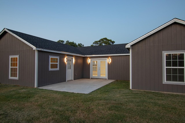 back of house featuring french doors, a shingled roof, a yard, and a patio