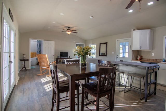 dining room featuring ceiling fan, dark hardwood / wood-style flooring, and vaulted ceiling