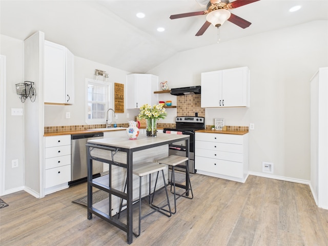 kitchen with lofted ceiling, open shelves, a sink, stainless steel appliances, and exhaust hood