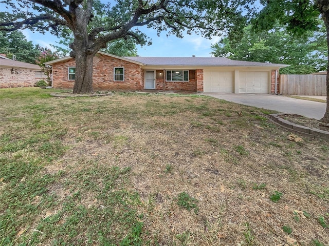 single story home featuring a garage and a front lawn