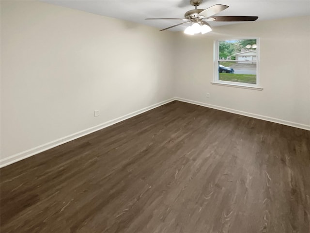 spare room featuring ceiling fan and dark hardwood / wood-style flooring