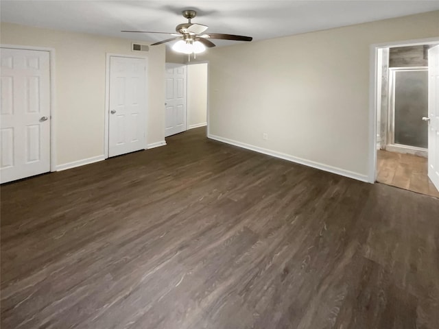 unfurnished bedroom featuring ceiling fan, connected bathroom, and dark hardwood / wood-style flooring