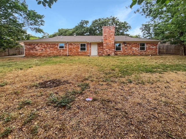 back of property featuring a yard