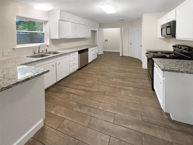 kitchen with stainless steel dishwasher, white cabinetry, sink, dark hardwood / wood-style floors, and range with electric cooktop