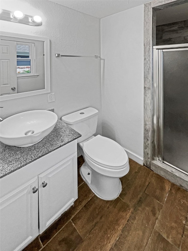 845 Dianna Ave, Hurst, TX 76053 - full bathroom with a stall shower, vanity, wood finished floors, and toilet