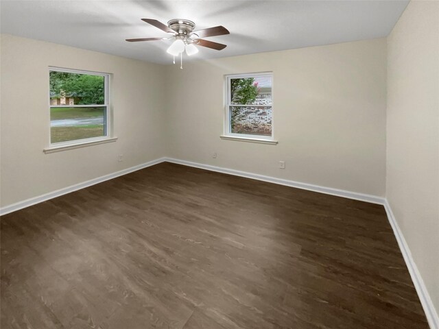 unfurnished room with ceiling fan and dark hardwood / wood-style flooring