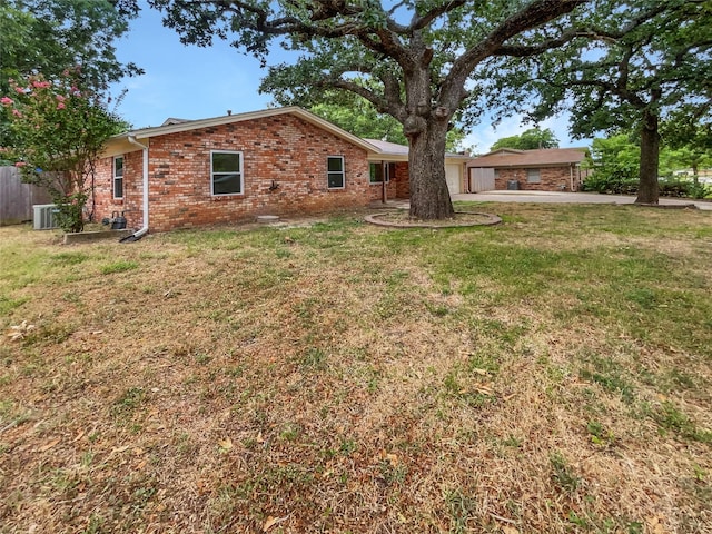 exterior space featuring central AC and a lawn