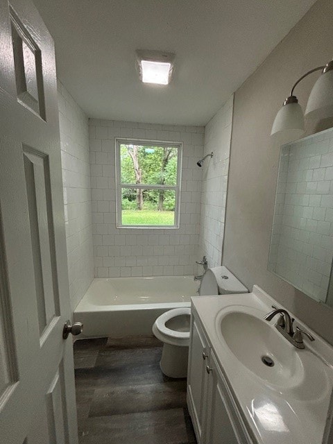 full bathroom featuring vanity, tiled shower / bath, toilet, and wood-type flooring