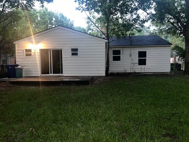 back of house with a lawn