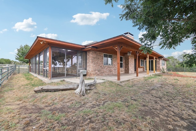 back of house with a patio and a sunroom