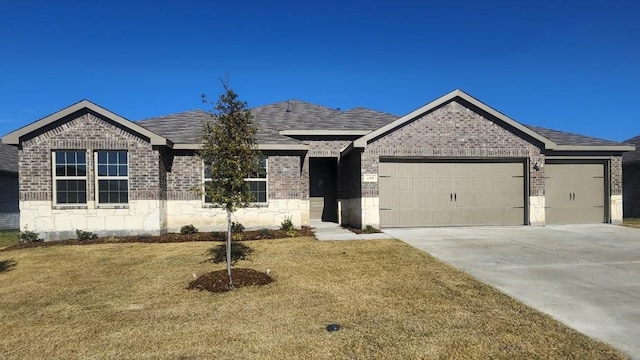 single story home featuring an attached garage, brick siding, a shingled roof, driveway, and a front yard