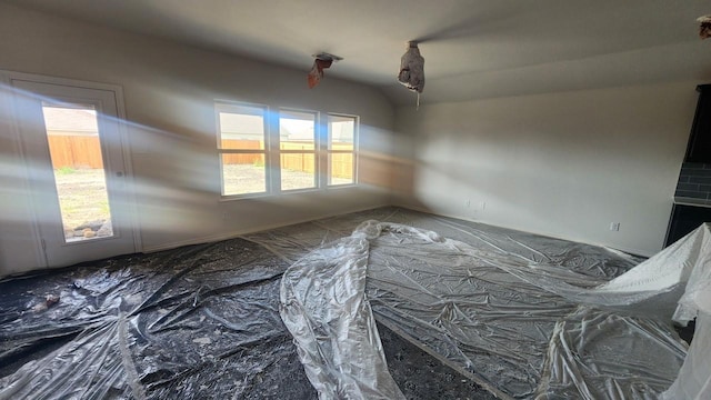 unfurnished room featuring vaulted ceiling