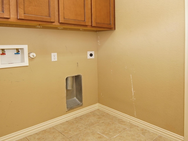 laundry room featuring cabinets, electric dryer hookup, washer hookup, and light tile patterned floors