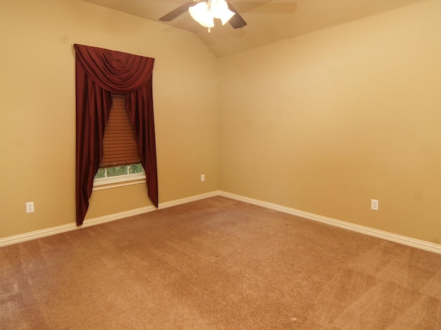 spare room featuring carpet, lofted ceiling, and ceiling fan