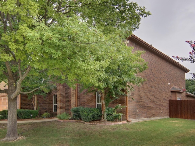 view of home's exterior with a lawn