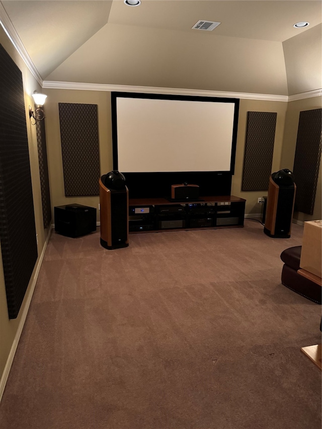 carpeted home theater featuring crown molding and vaulted ceiling