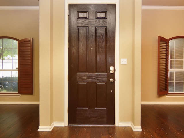 entryway featuring hardwood / wood-style floors and ornamental molding