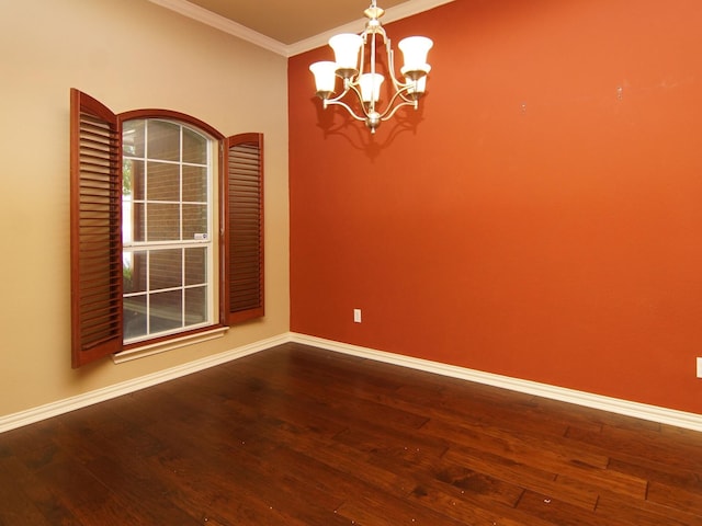 empty room featuring crown molding, wood-type flooring, and a chandelier