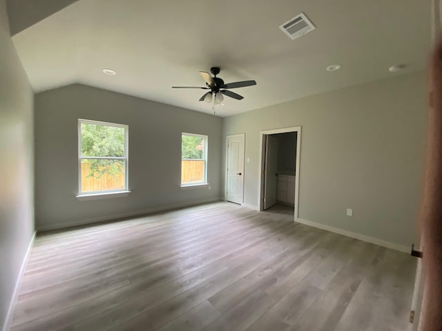 unfurnished bedroom featuring light wood-type flooring, ceiling fan, and lofted ceiling