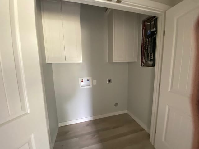 clothes washing area featuring cabinets, electric dryer hookup, dark hardwood / wood-style floors, and hookup for a washing machine