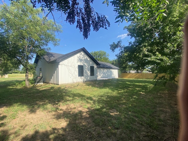 view of side of property with a lawn