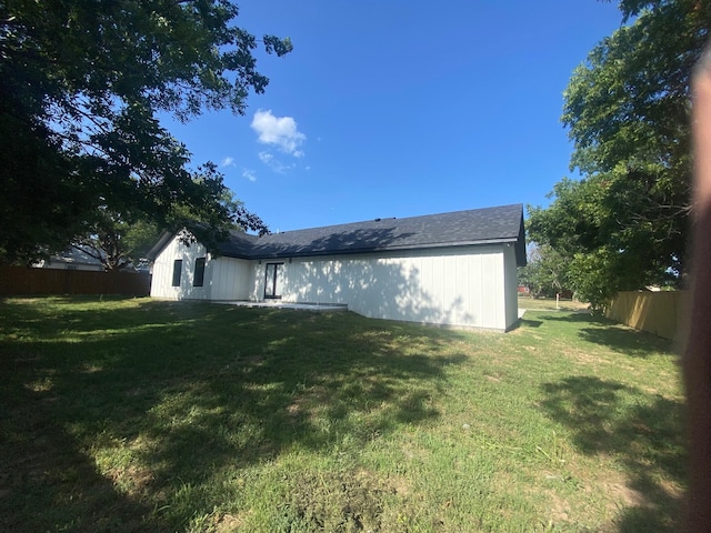 rear view of house with a yard