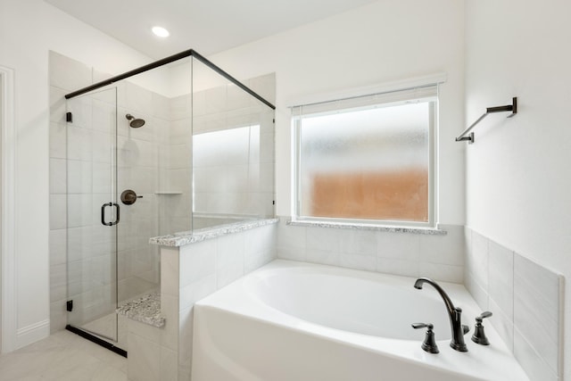 bathroom with shower with separate bathtub