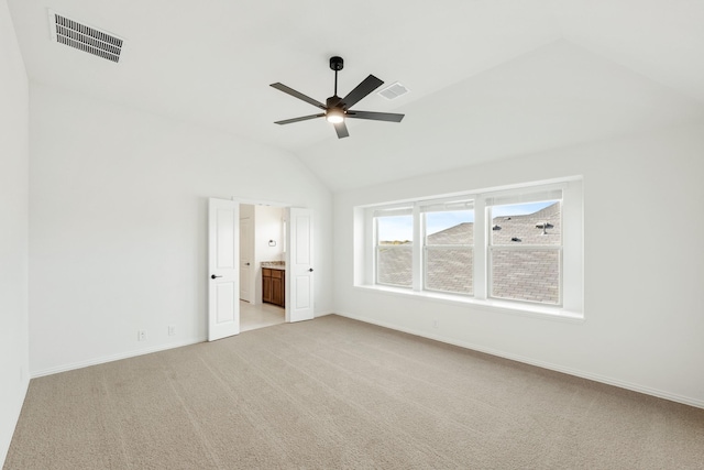 interior space featuring light carpet, ceiling fan, and lofted ceiling